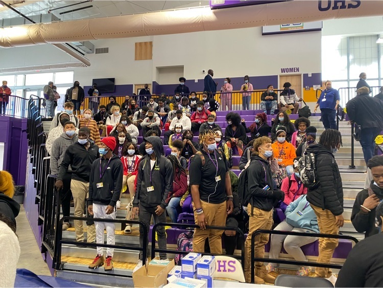 students standing in bleachers at a college fair