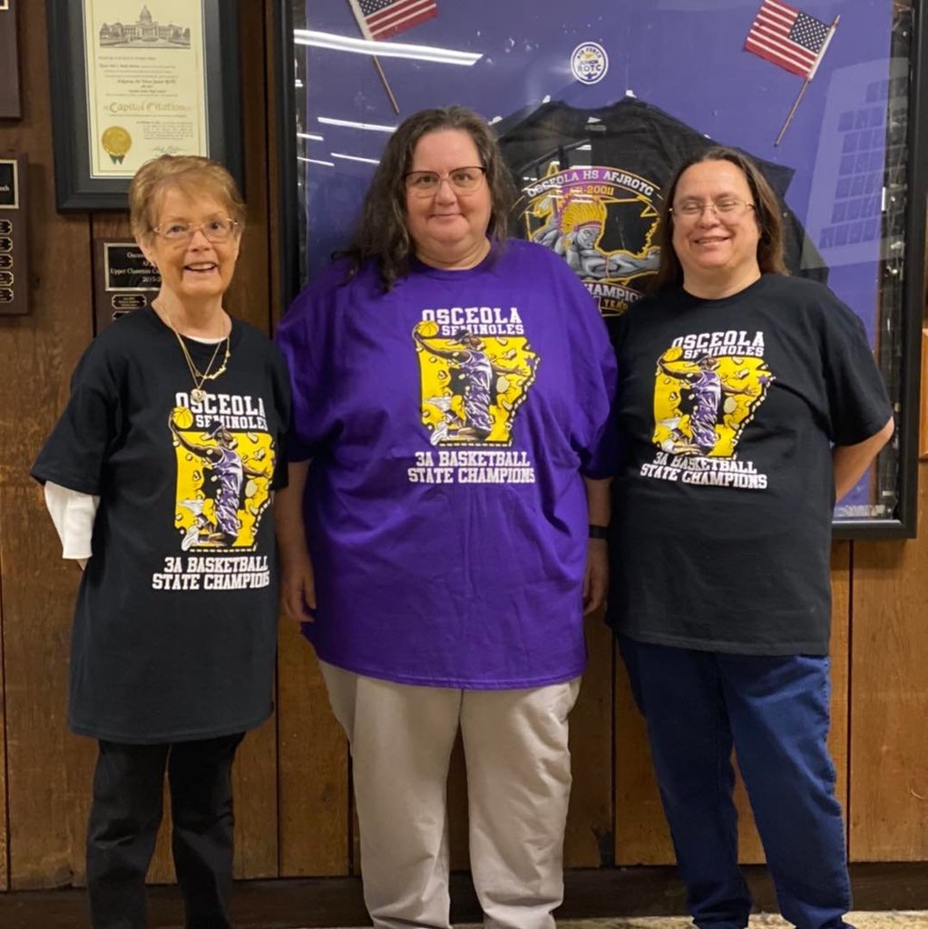 group of women in purple and black shirts