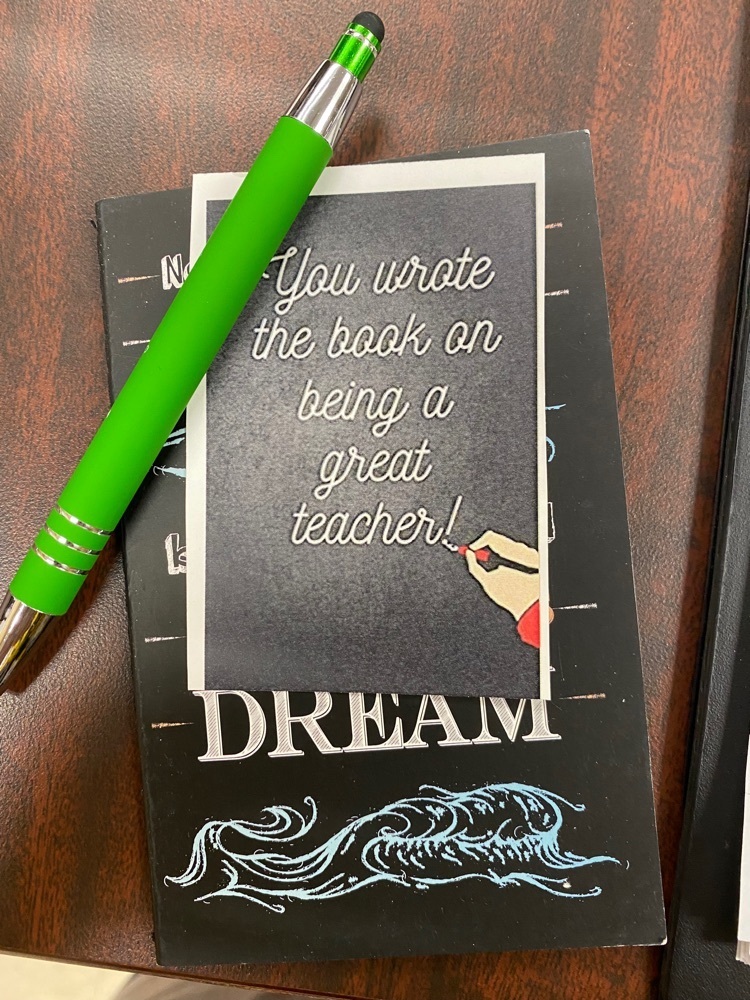 a picture of a notebook and a pen with writing on it