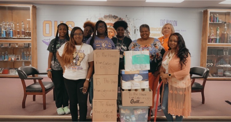 picture of students, teachers, and community members with donations 
