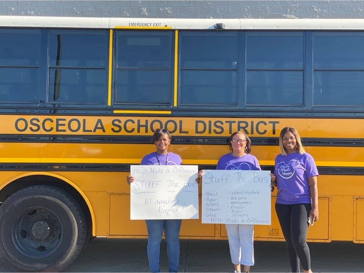 picture of women with signs and a bus
