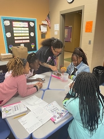 Ms. Estell assists students.