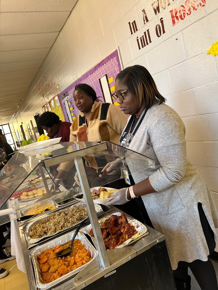 Choices Faculty serve the students plate for their Thanksgiving meal. 